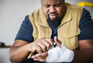 A man wrapping his hand that he injured in a workplace accident in Columbus columbus workplace injury attorneys